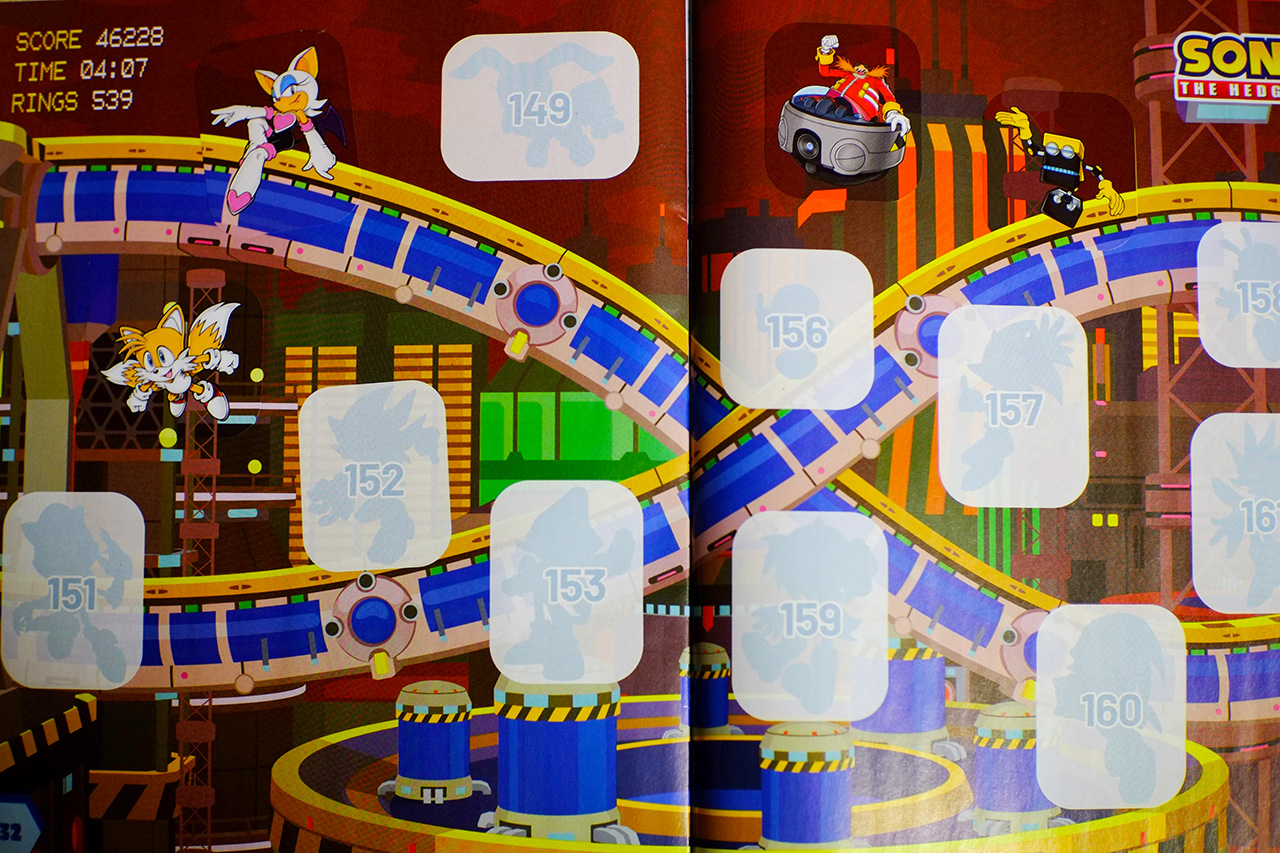 A photo of a page spread from Sonic the Hedgehog sticker album, featuring the Chemical Plant background and four stickers of Tails, Rouge, Doctor Eggman, and Cubot doing various poses.