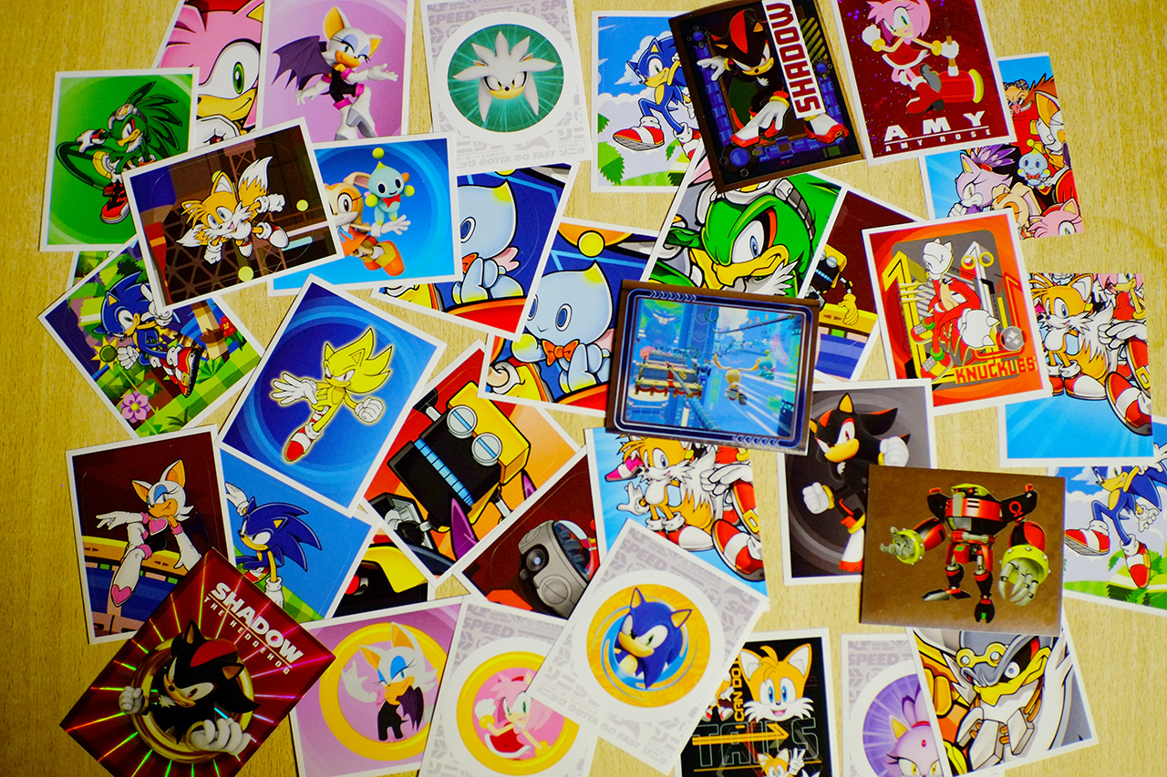 A photo of Sonic the Hedgehog stickers organized into a chaotic pile on a table.