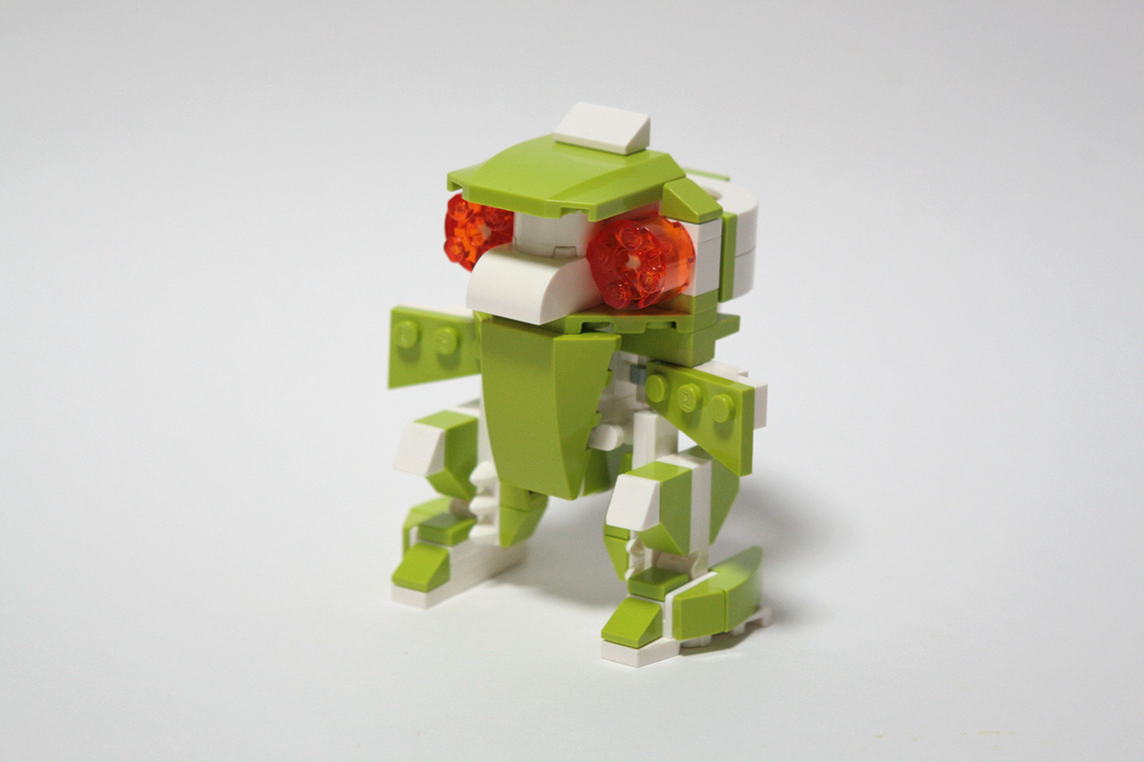 A front angle photo of a dinosaur / bird creature I made out of white and lime green LEGO pieces. It has two big wide legs, a big head with two big round transparent orange eyes, and two very small lime green wings.