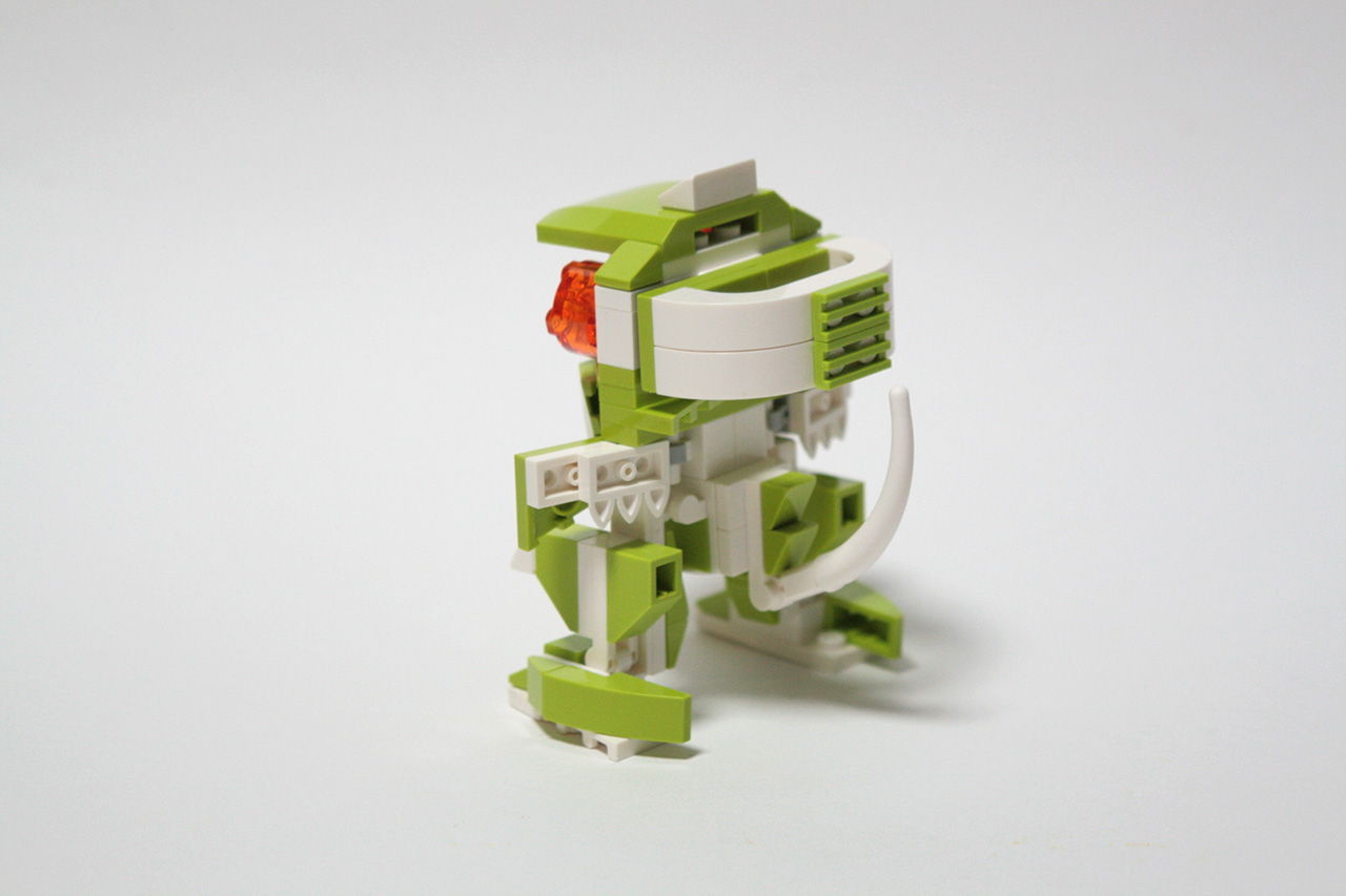 A back angle photo of the same custom LEGO build, featuring a long white tail and a big white arc-like part on the back of the creature's head.